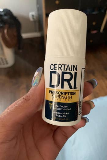 reviewer holding up a packacge of certain dri prescription strength deodorant