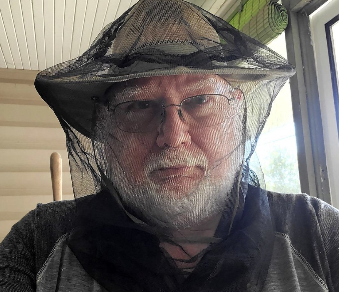 A person wearing the net over their hat