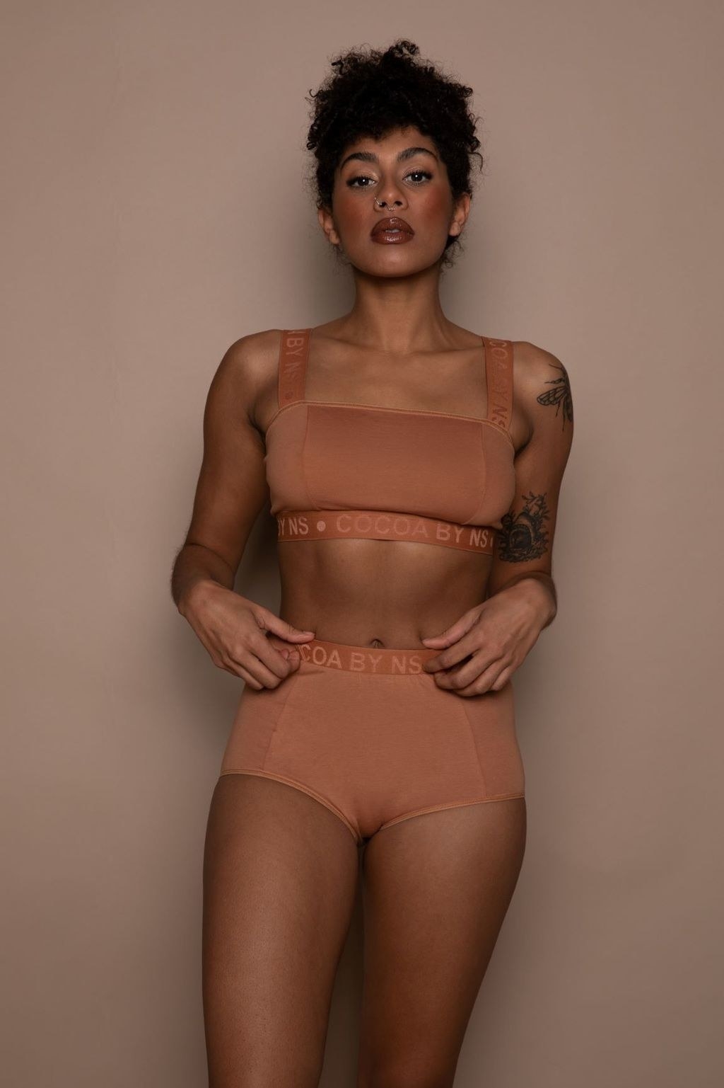 model wearing a nude-colored bralette and boy short