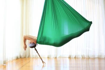 Person laying inside the hanging fabric 