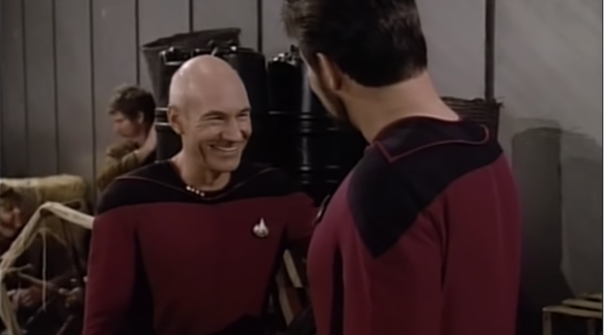 Stewart as Picard laughs in his too-tight costume