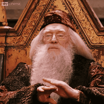 Dumbledore from Harry Potter clapping daintily 