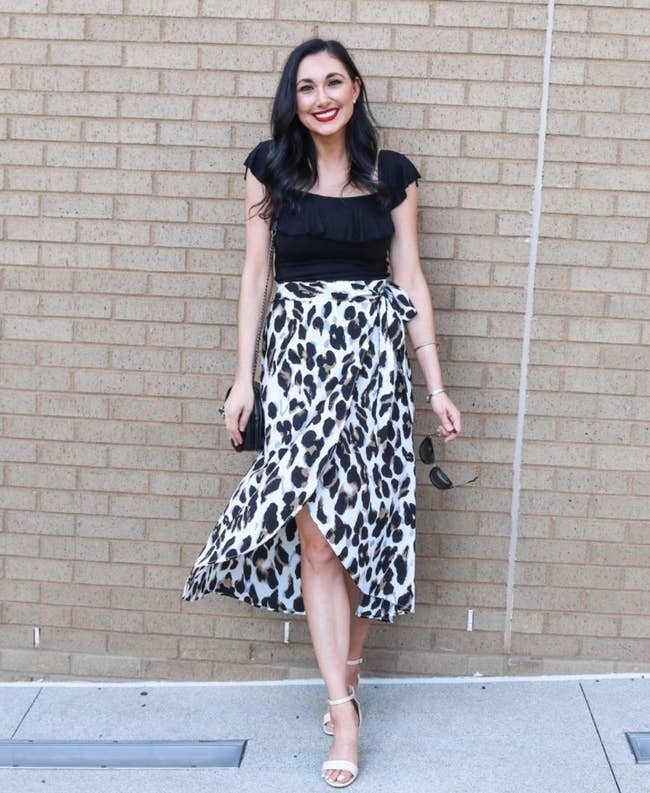 Reviewer photo of a person wearing a leopard skirt and black top