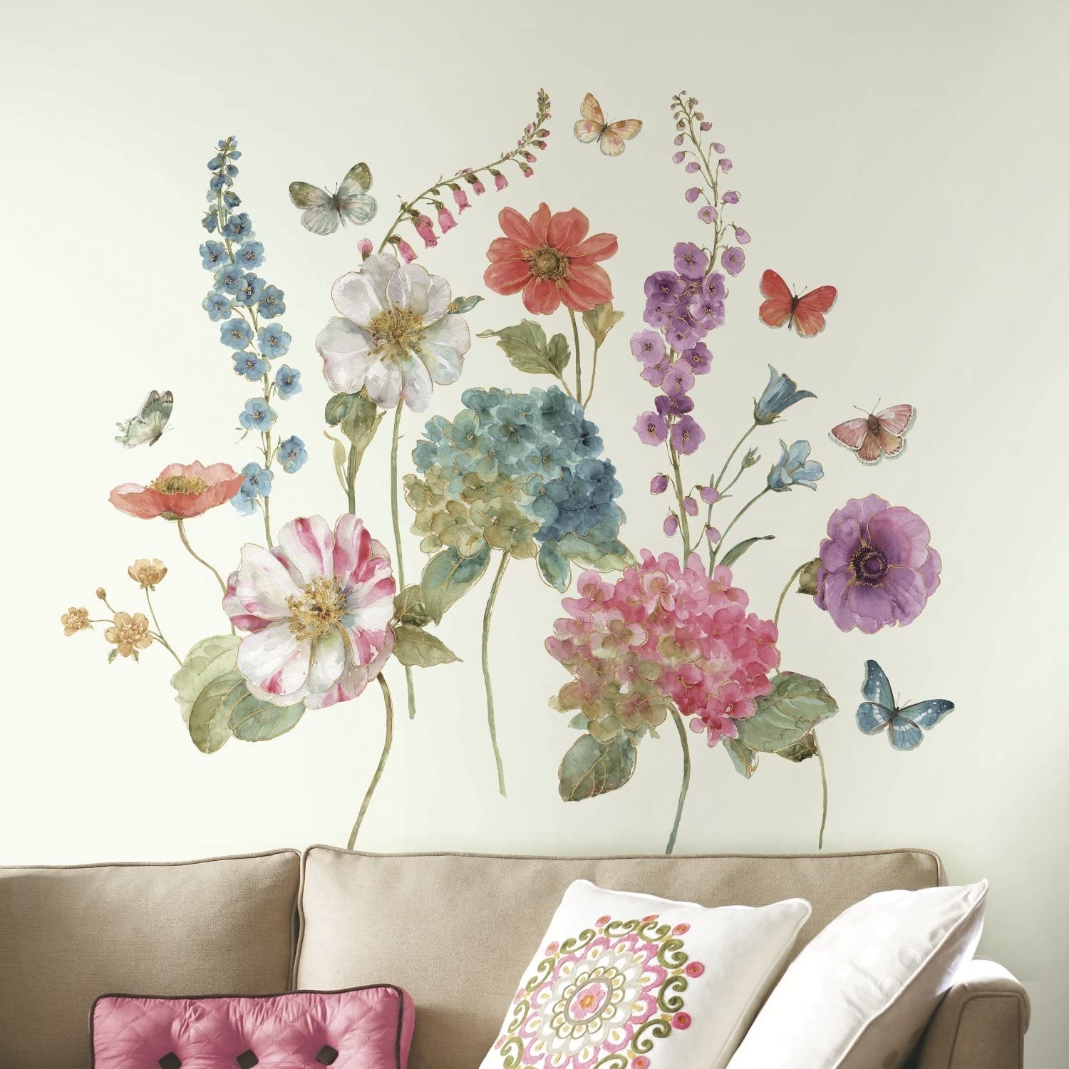 big flower stickers on a wall above a couch 