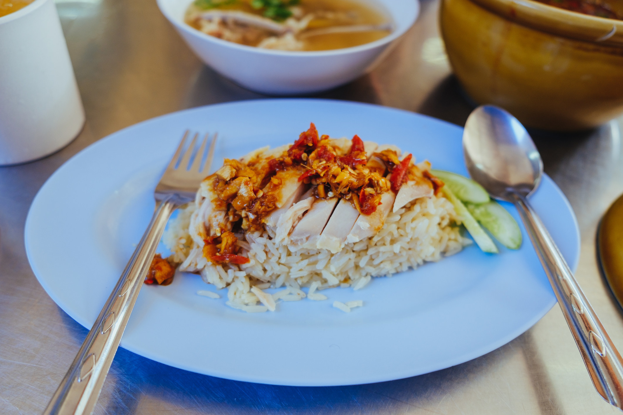 Hainanese chicken rice with spicy chili oil.