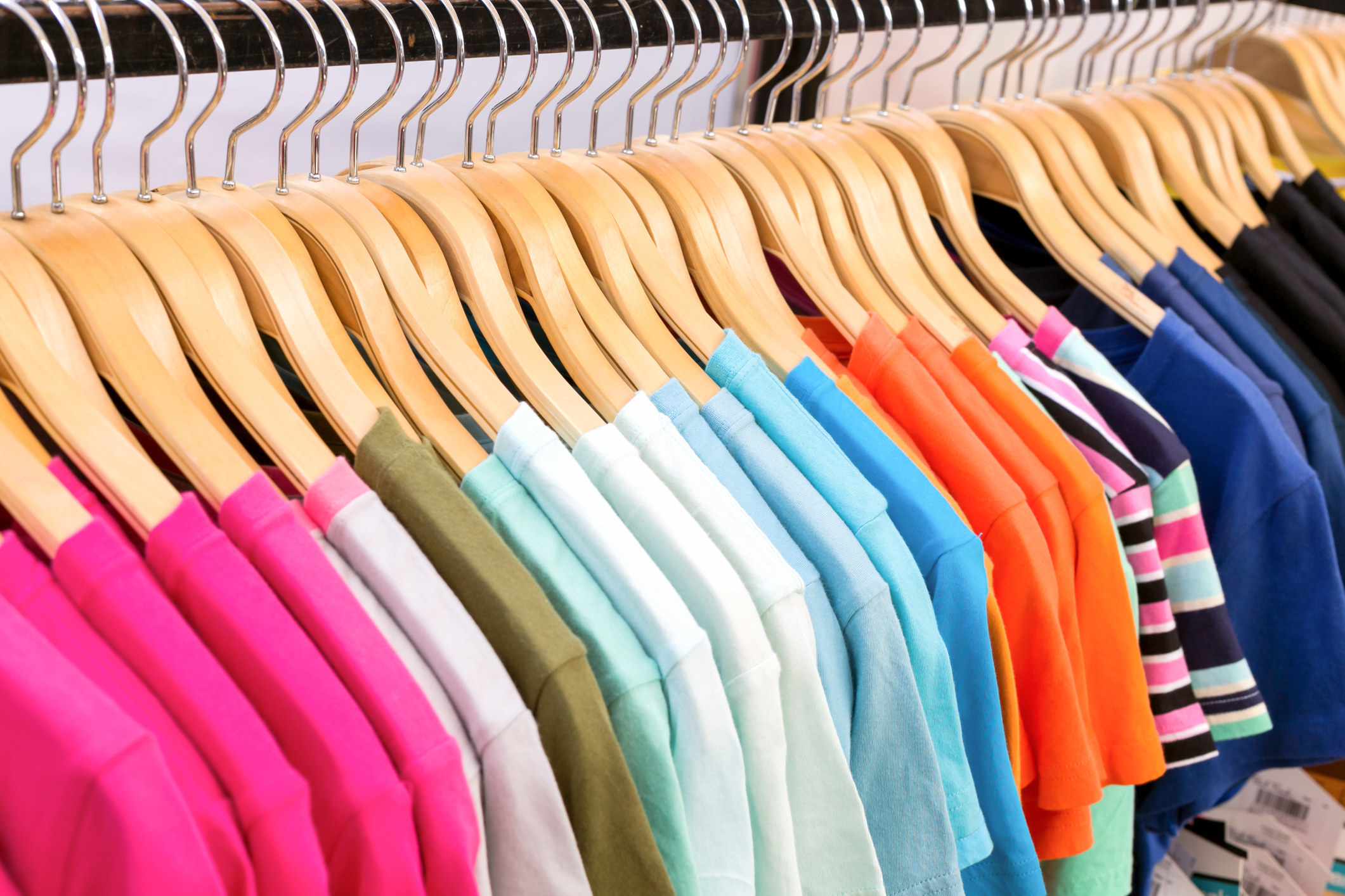 Close up of colourful t-Shirts hanging on a rack in-store