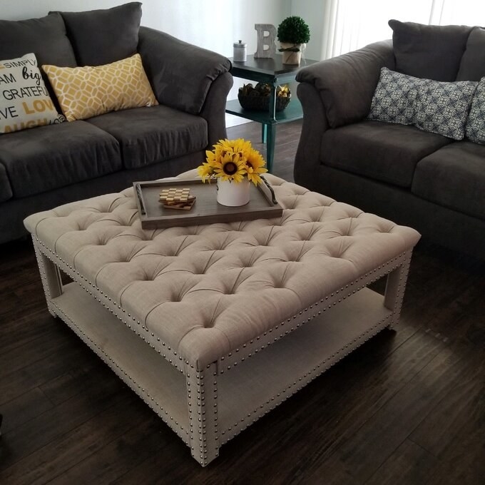 A reviewer photo of the ottoman in beige