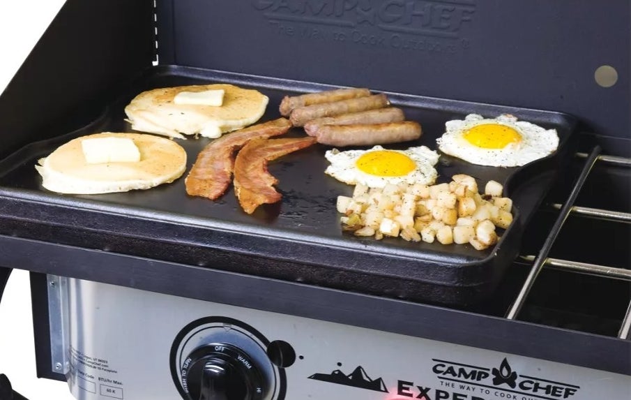 Cast Iron cooking eggs, pancakes, bacon, sausage, and hash browns