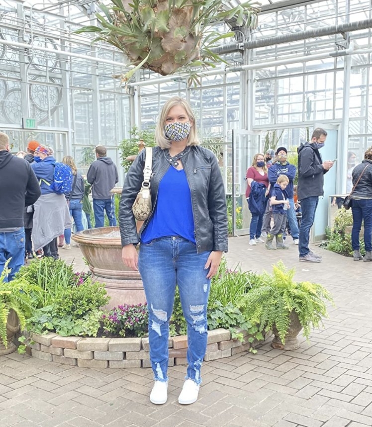 A reviewer wearing a blue top and denim jeans
