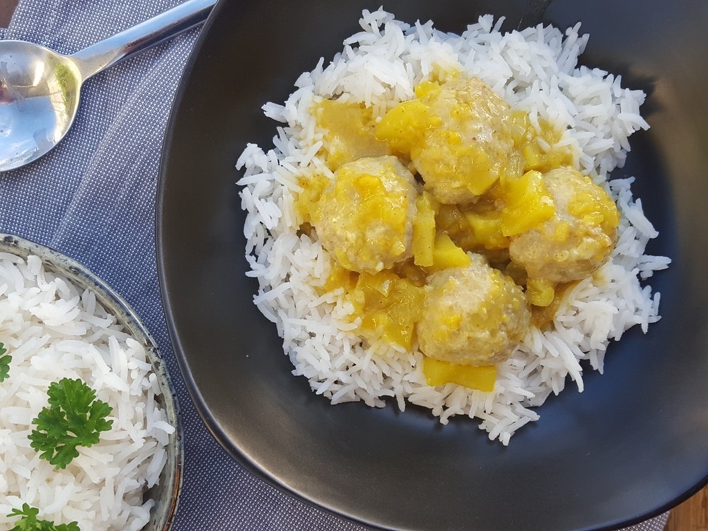 Meatballs in curry sauce over rice.