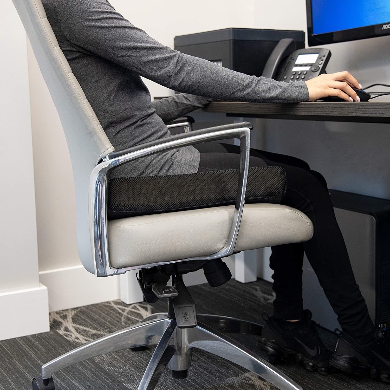 A person sitting on a chair with the cushion under their butt