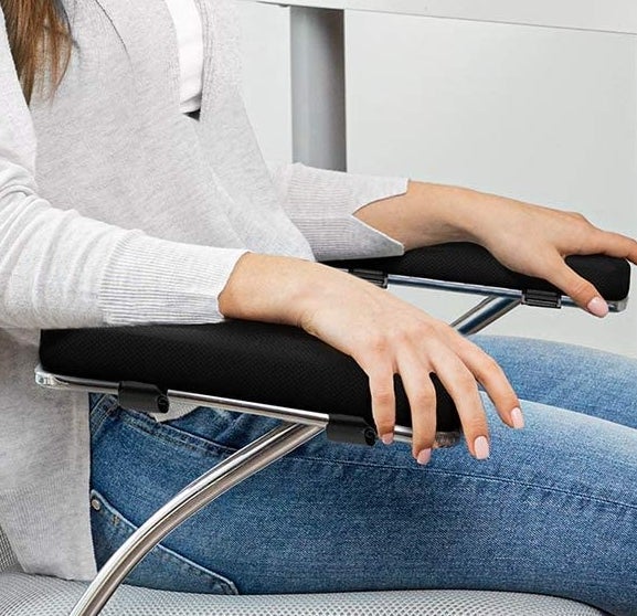 A person resting their arms on the arm rests