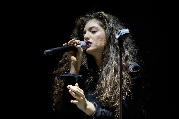 Lorde onstage singing