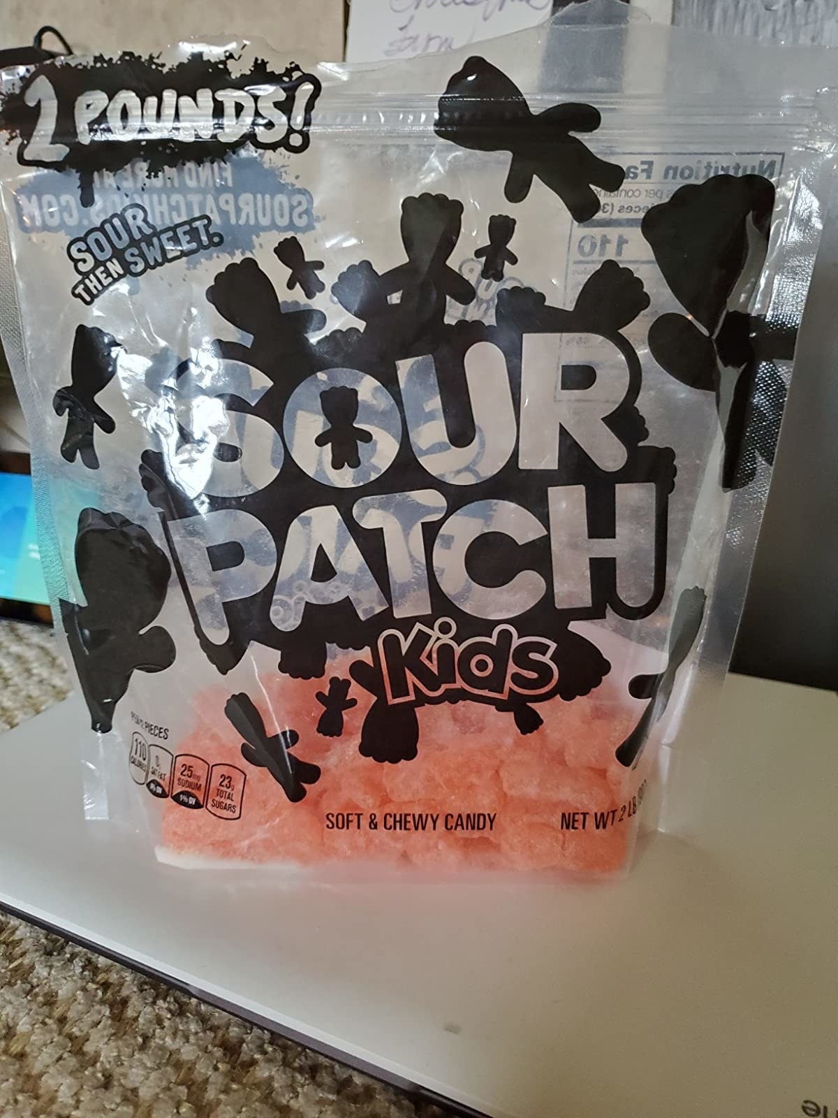 a reviewer&#x27;s image of a 2 pound bag of orange sour patch kids