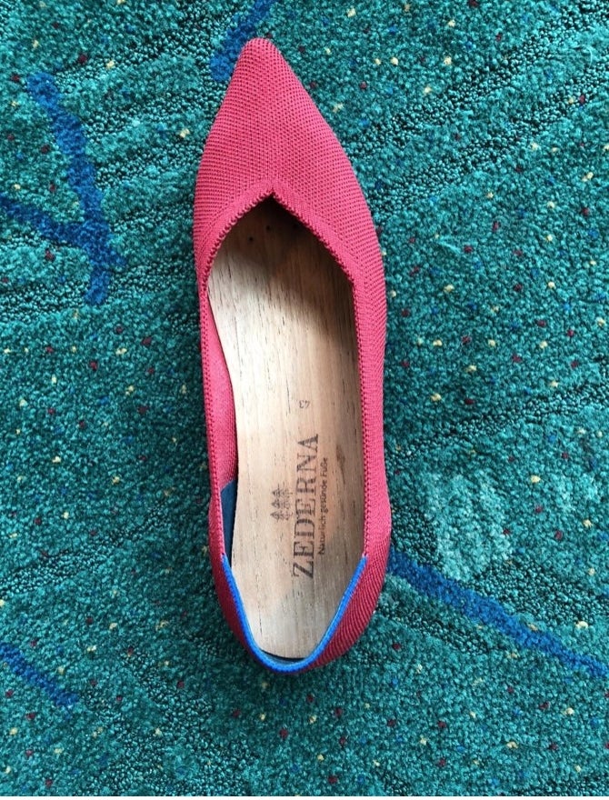 A pair of pink flats with the wood insole