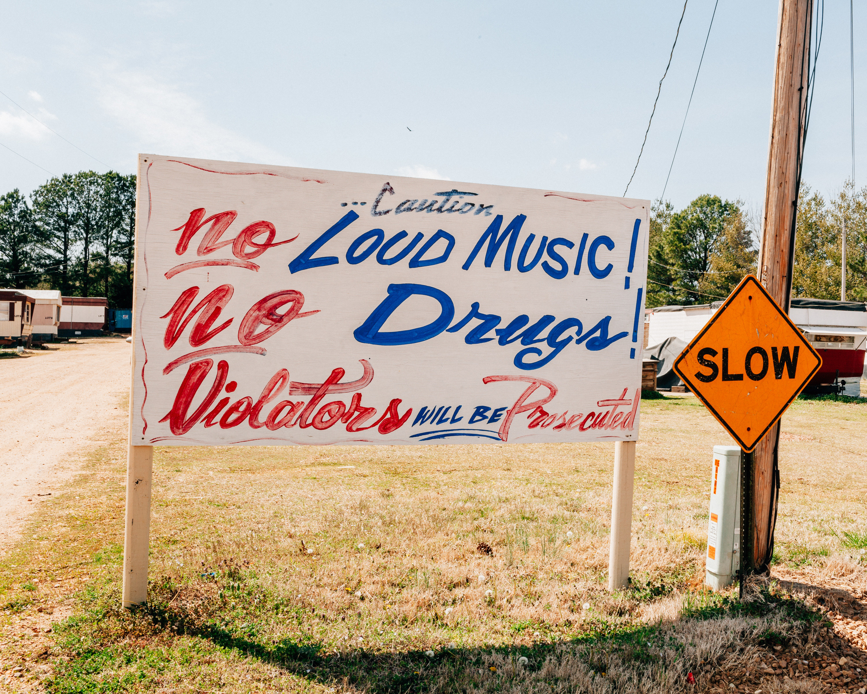 A hand-painted sign reads &quot;no loud music, no drugs, violaters will be prosecuted&quot;