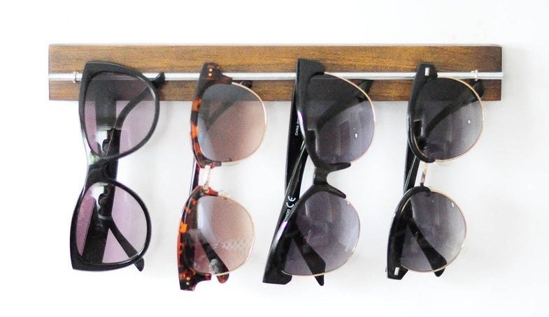 The sunglass organizer on a wall filled with sunglasses