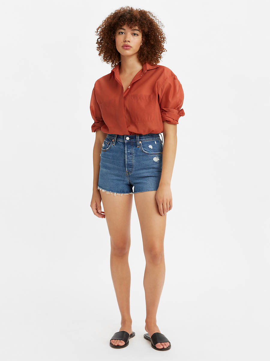 model in medium wash jean shorts