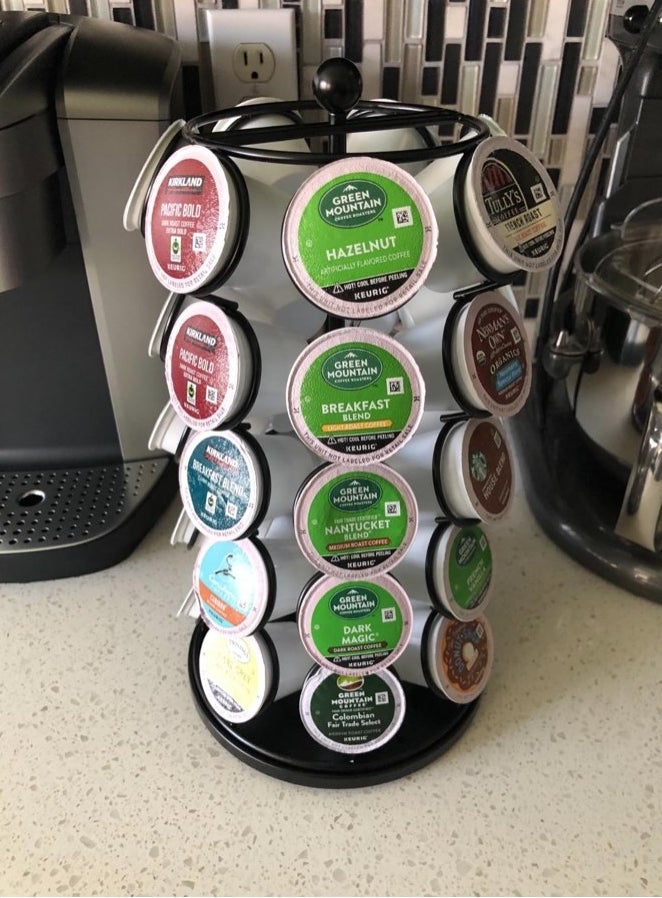 A black k-cup organizer filled with various colored pods