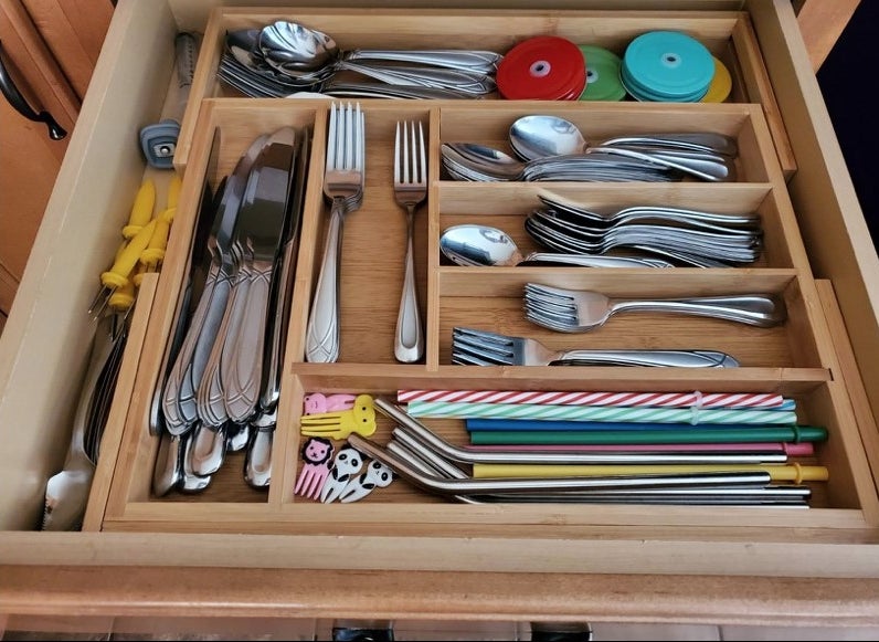 A bamboo insert in a drawer filled with flatware
