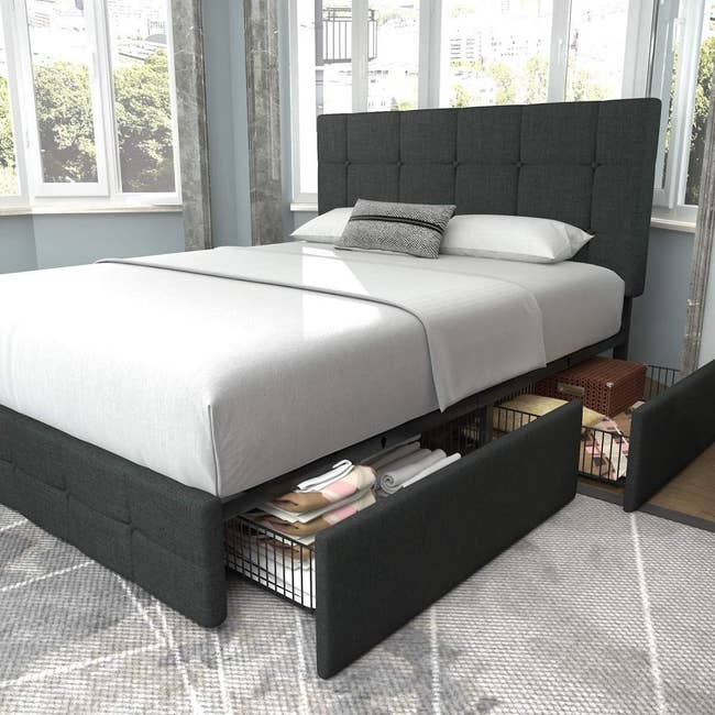 Platform bed with two drawers open in room