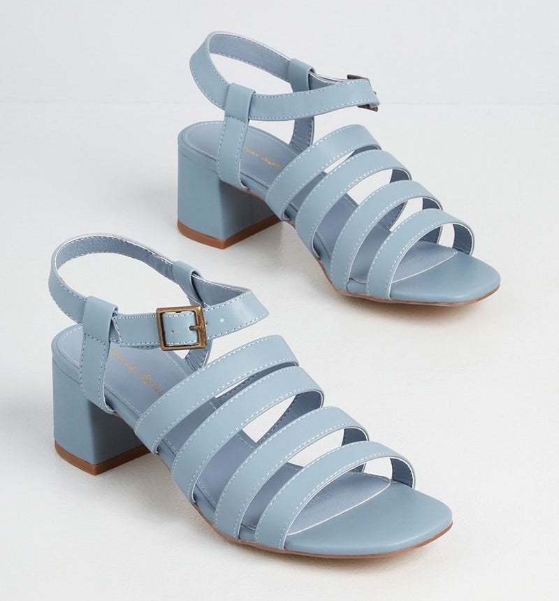 a pair of light blue multi-strap sandals with a buckle ankle strap and a block heel 