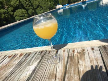 Wine glass sitting on a pool deck