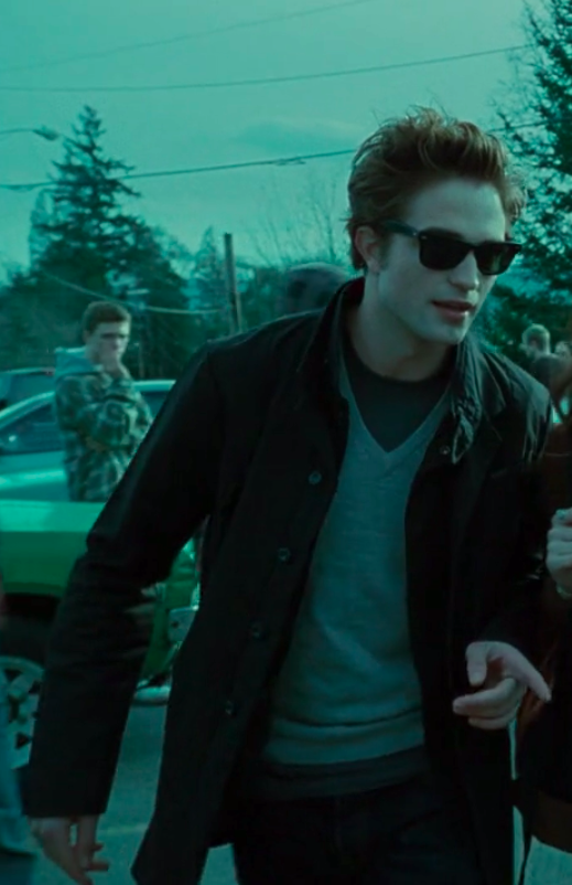 Edward wearing pants, a shirt, a sweater, a jacket, and sunglasses