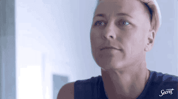 GIF of Abby Wambach speaking to the camera and looking in a mirror