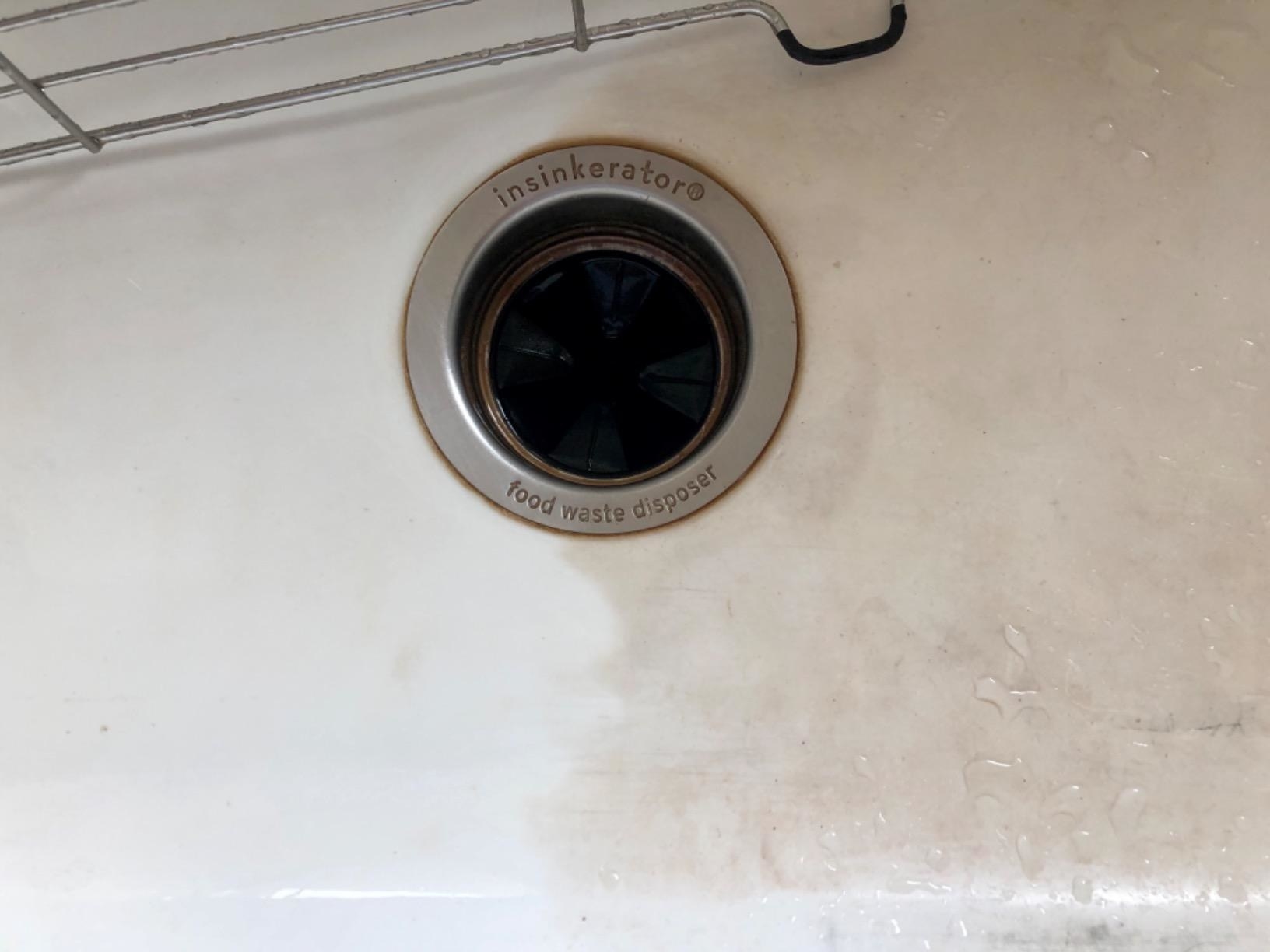 reviewer image of a sink half white and clean and half dirty and brown