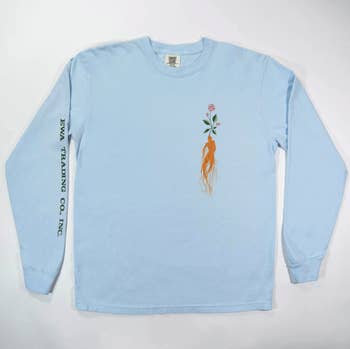 A blue long-sleeve tee featuring  a ginseng on the front and the business name EWA Trading Inc Co down the sleeve 
