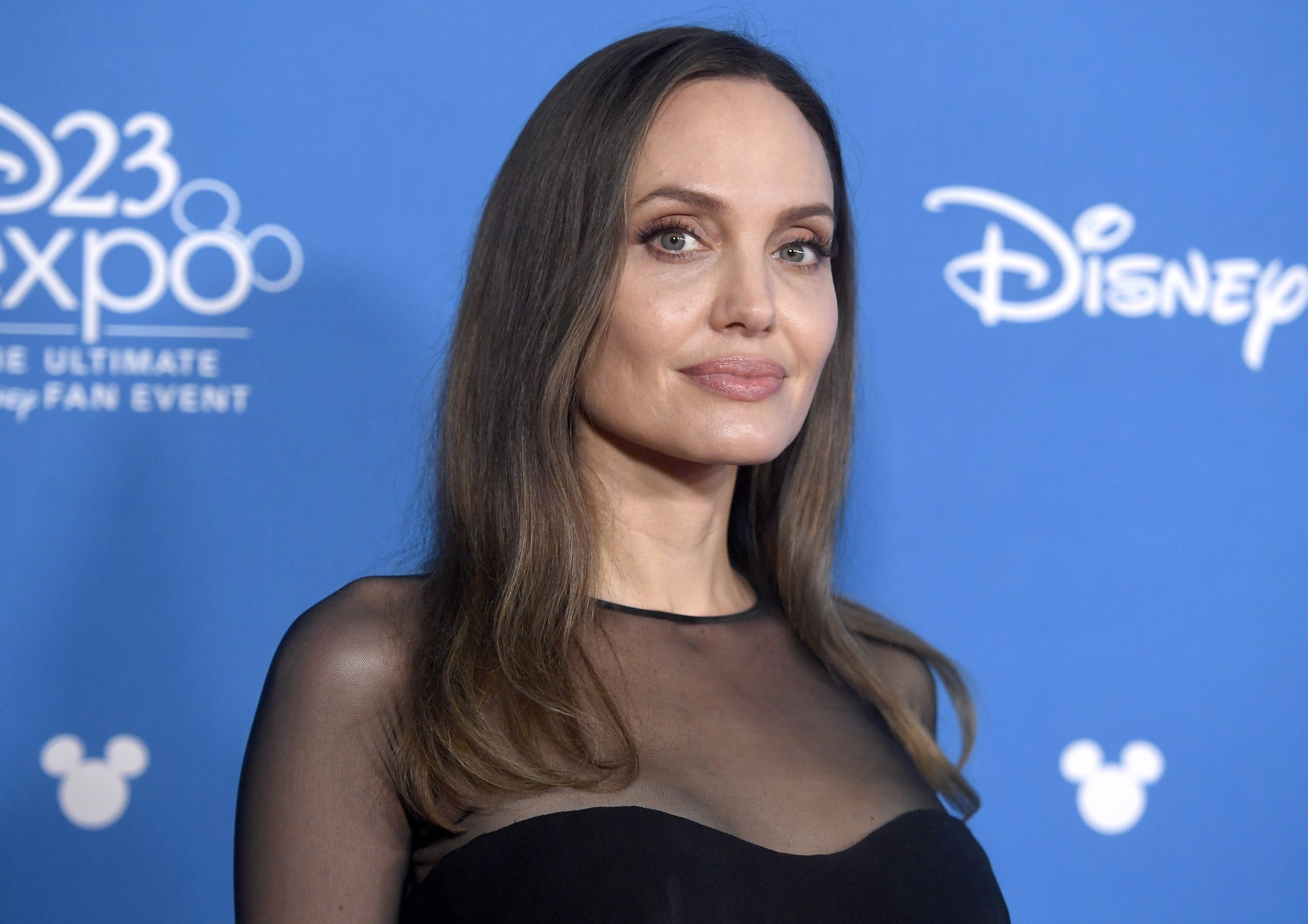 Angelina wears a sheer black top to an event