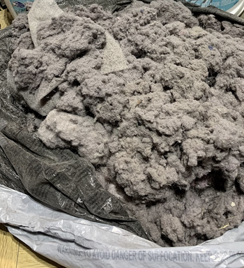 different reviewer image of garbage bag filled 3/4th full with lint