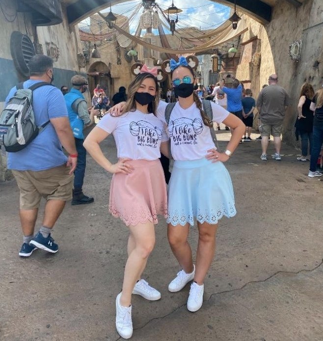 a reviewer and their sister wearing the skirts in pink and blue 