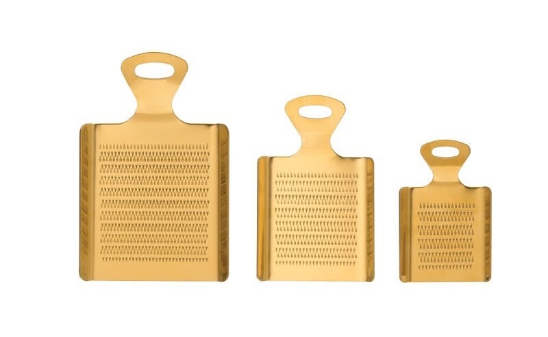 A trio of brass graters in varying sizes