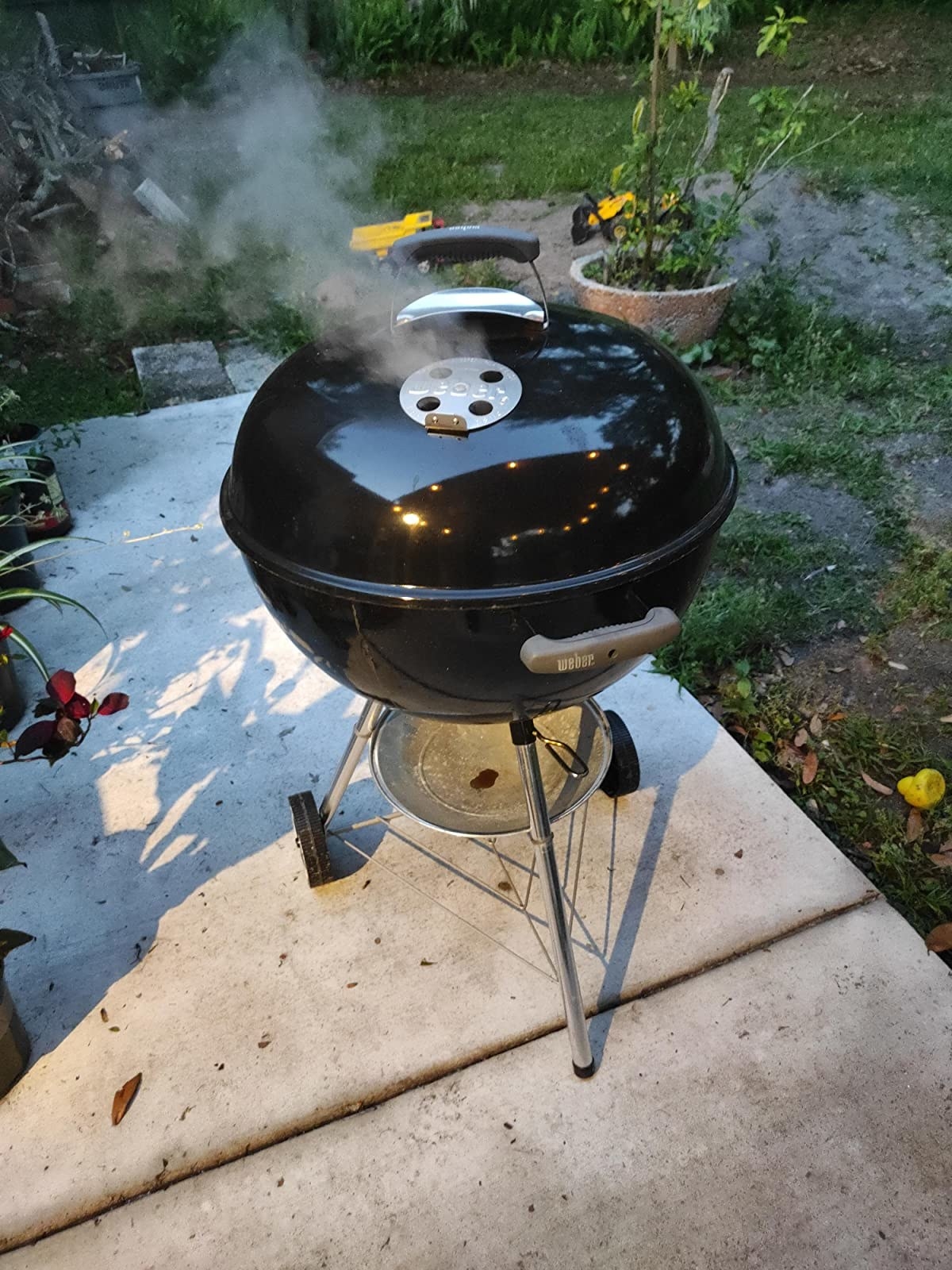 A grill being used in the backyard