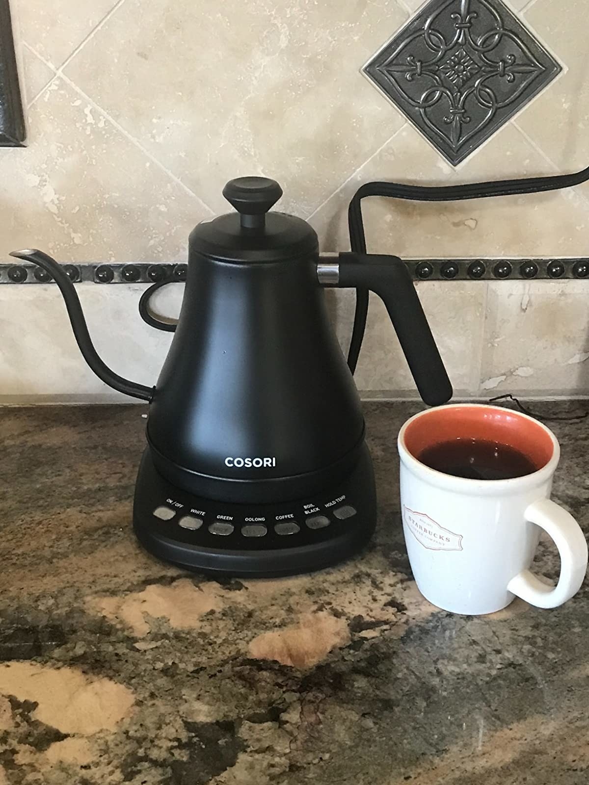 The black kettle with a cup of coffee