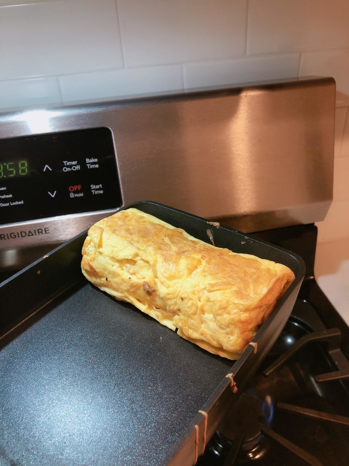 The pan being used to make a rolled omelet