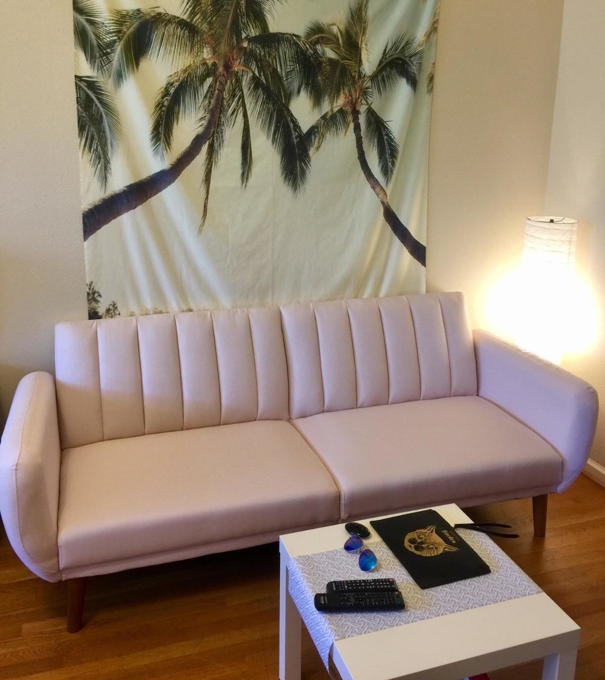 reviewer photo of a pink Novogratz futon