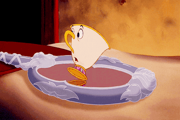 A GIF of Chip from Beauty and the Beast spinning on a mirror