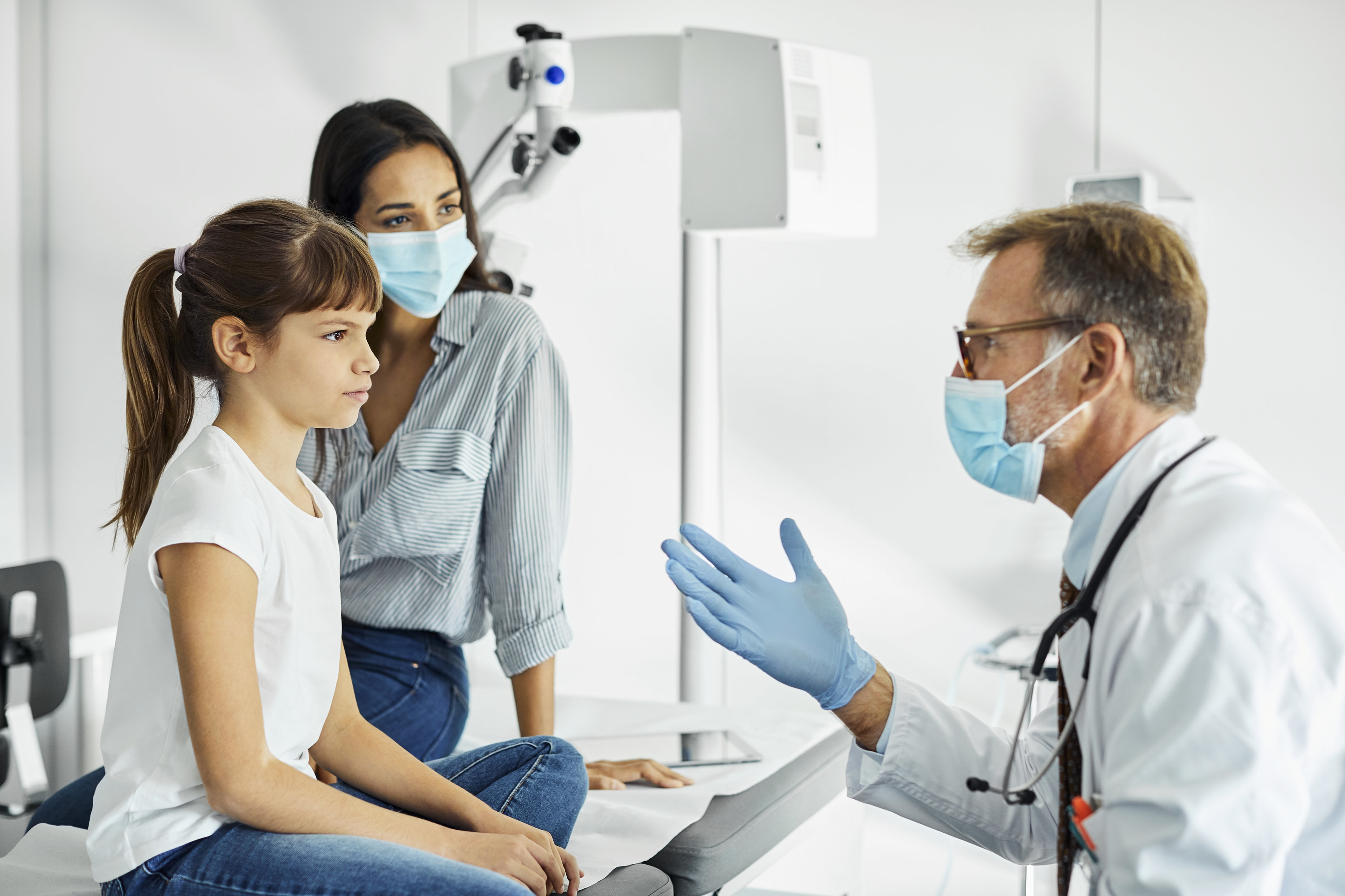 A mom and her daughter speaking with a doctor 