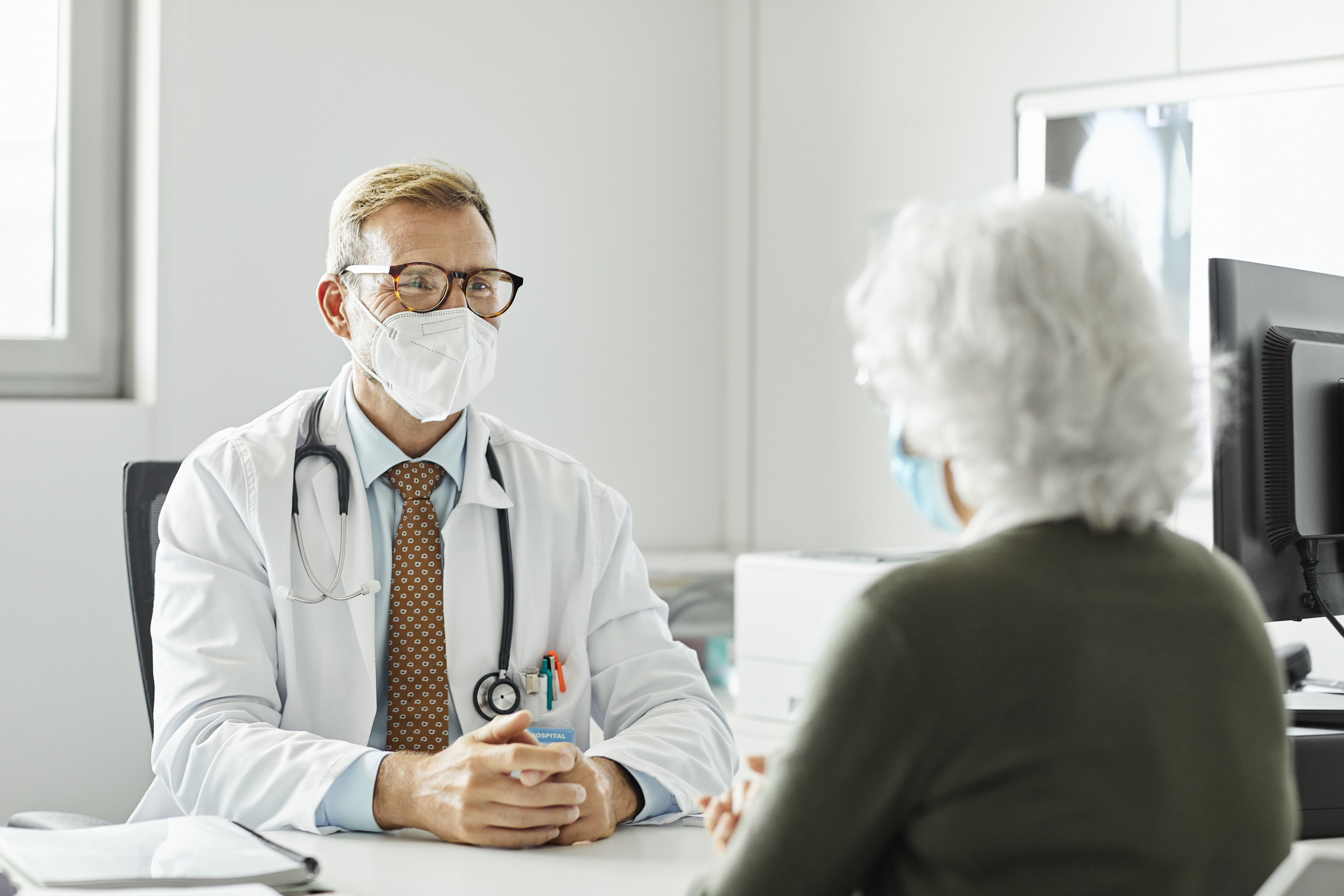 A doctor talking to a patient 