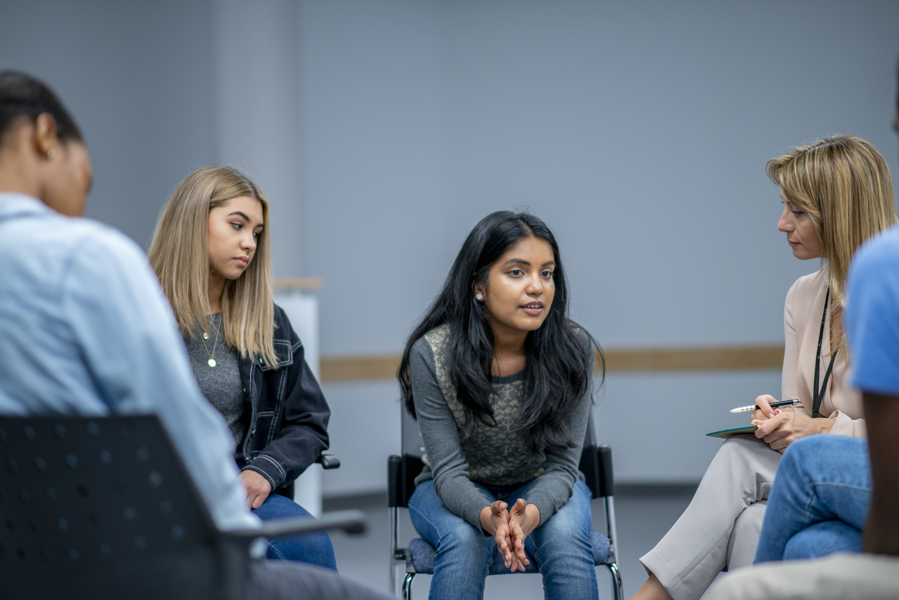 A young girl and her mom speaking with a doctor 