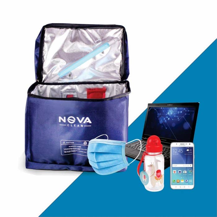 A device sanitisation bag next to a surgical mask and computing devices