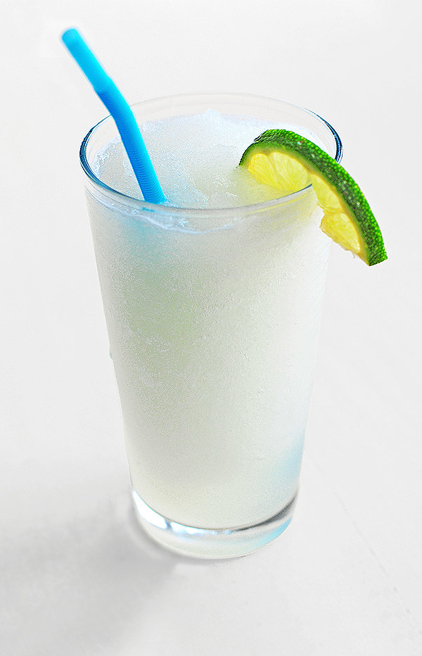 A glass containing a very icy coconut limeade