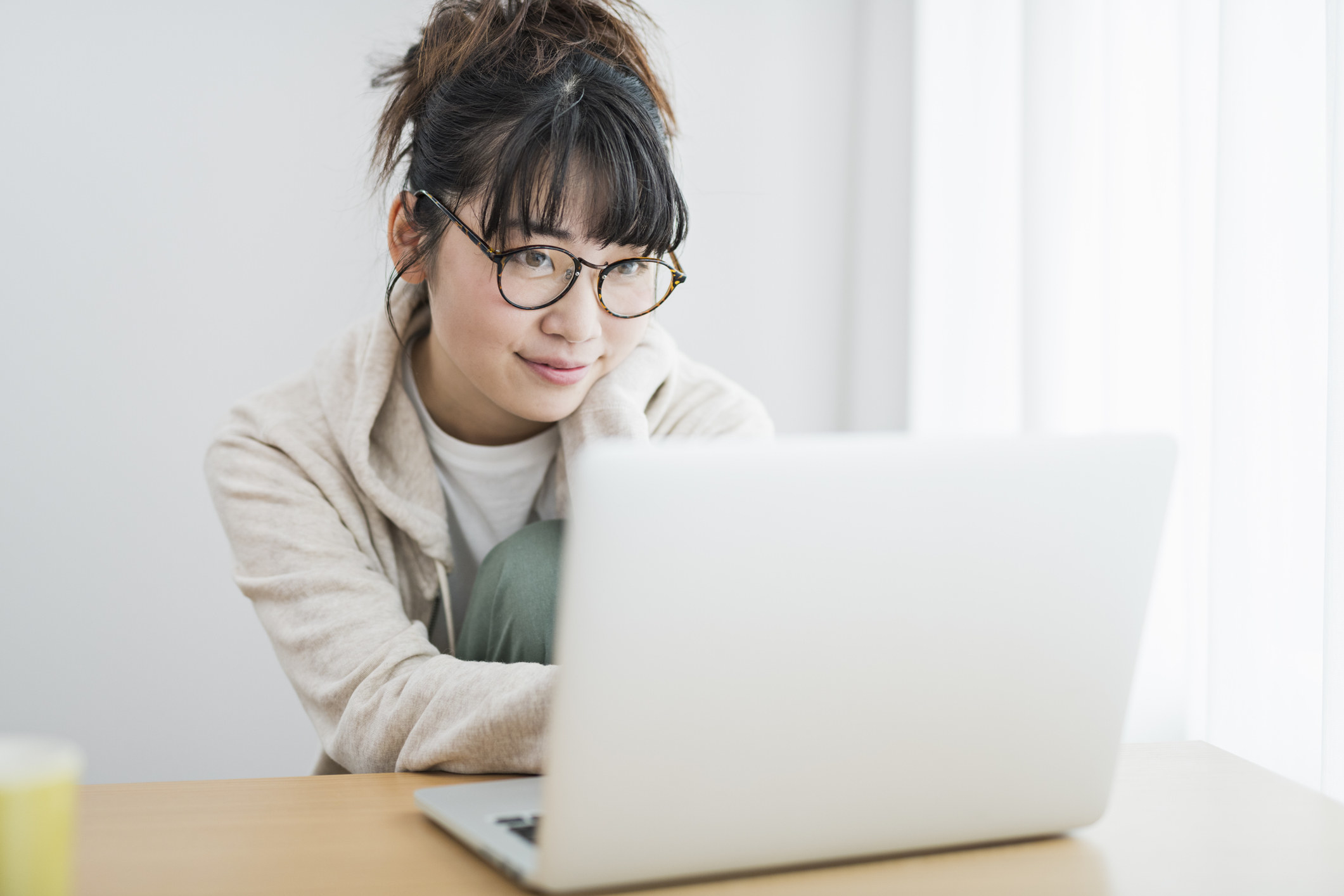 A young woman working on a laptop