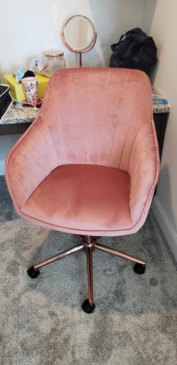 the blush pink office chair with rose gold legs that roll sitting at BuzzFeed editor Marquaysa's desk (that's me by the way)