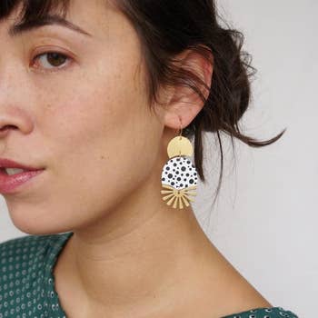 model wearing the gold and spotted drop earrings 