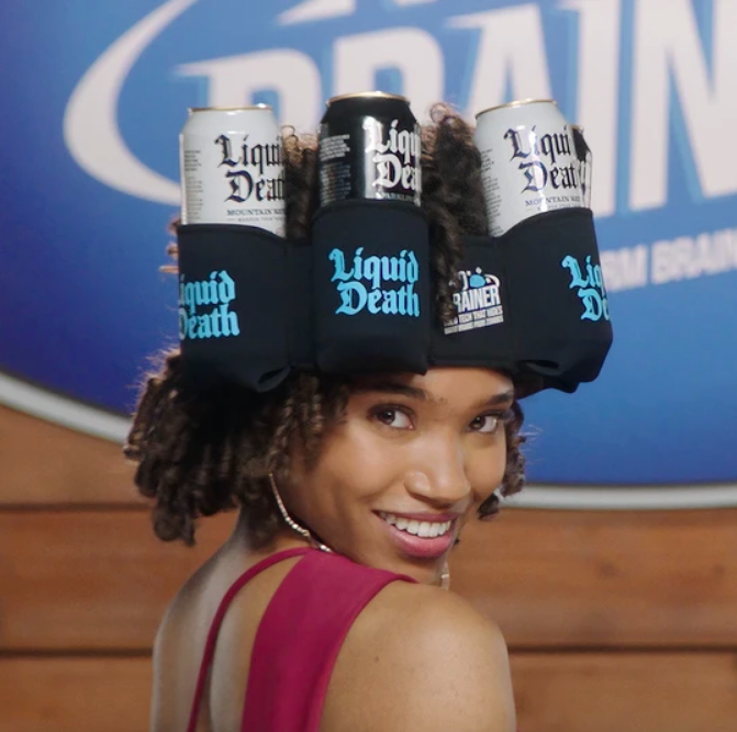 Model wearing several cans of water on their head, supported by a can cozy headband 