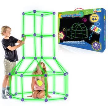 two children building a for with the poles and spheres